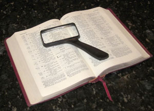 Bible with magnifying glass
